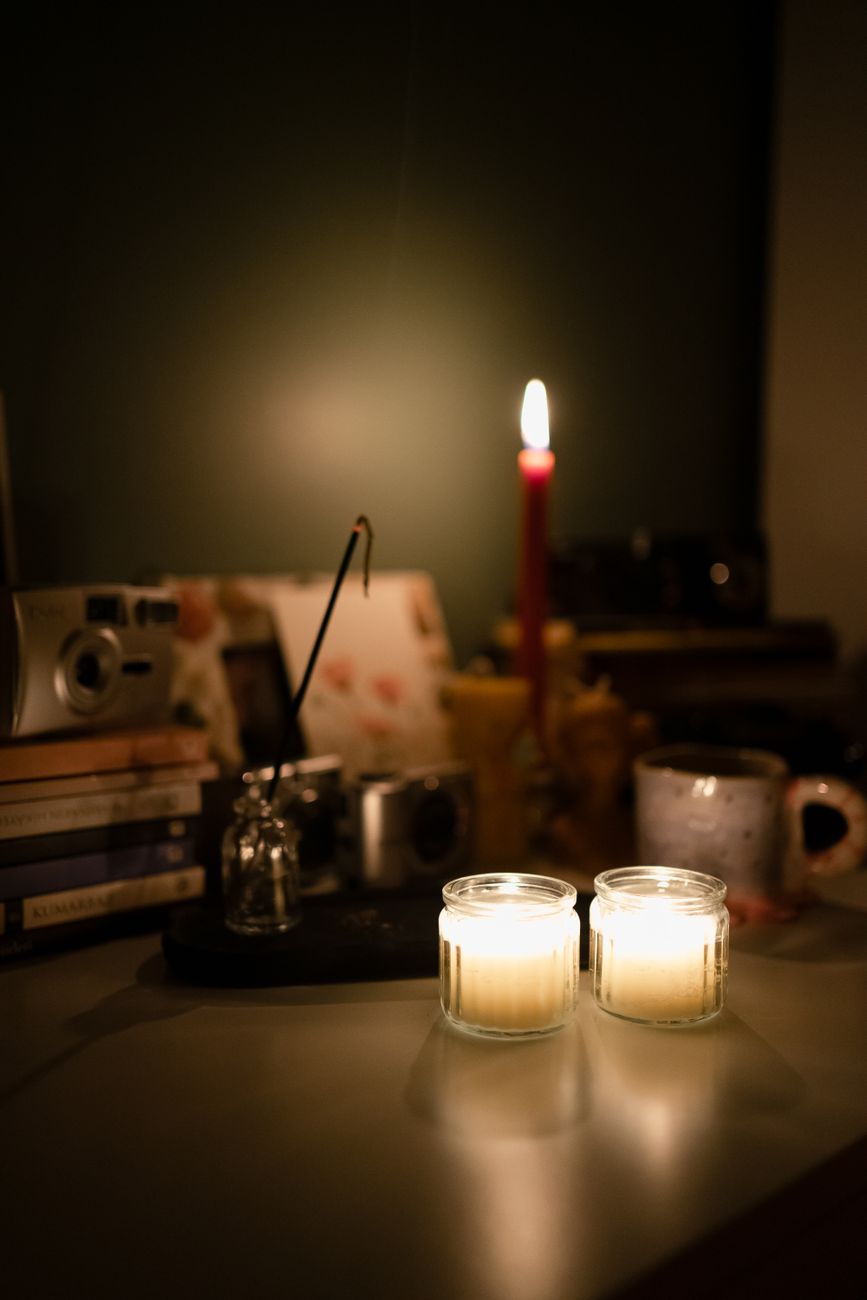 burning candles standing on a desk